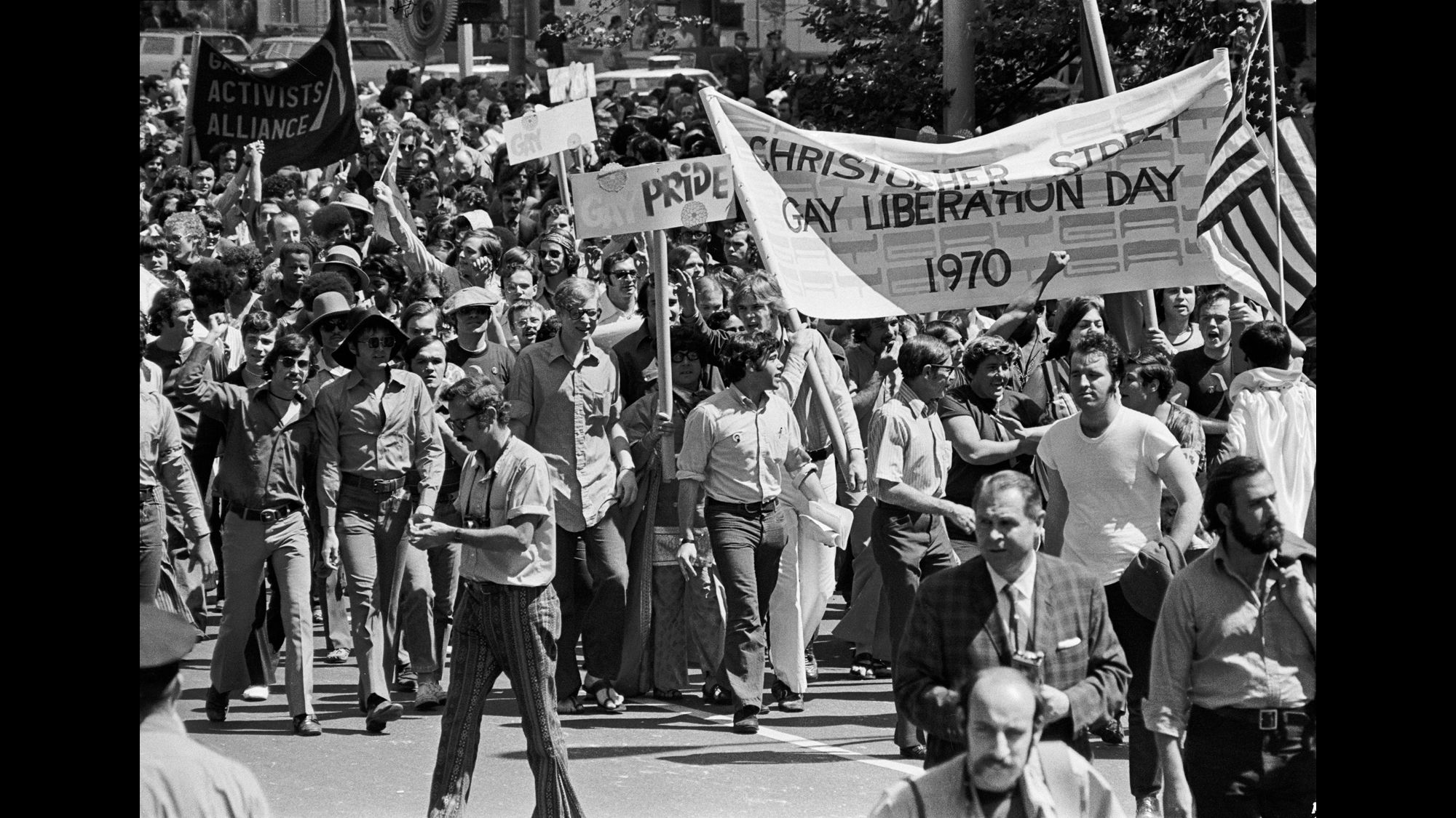 Marchers carry a banner reading Christopher Street Gay Liberation Day 1970